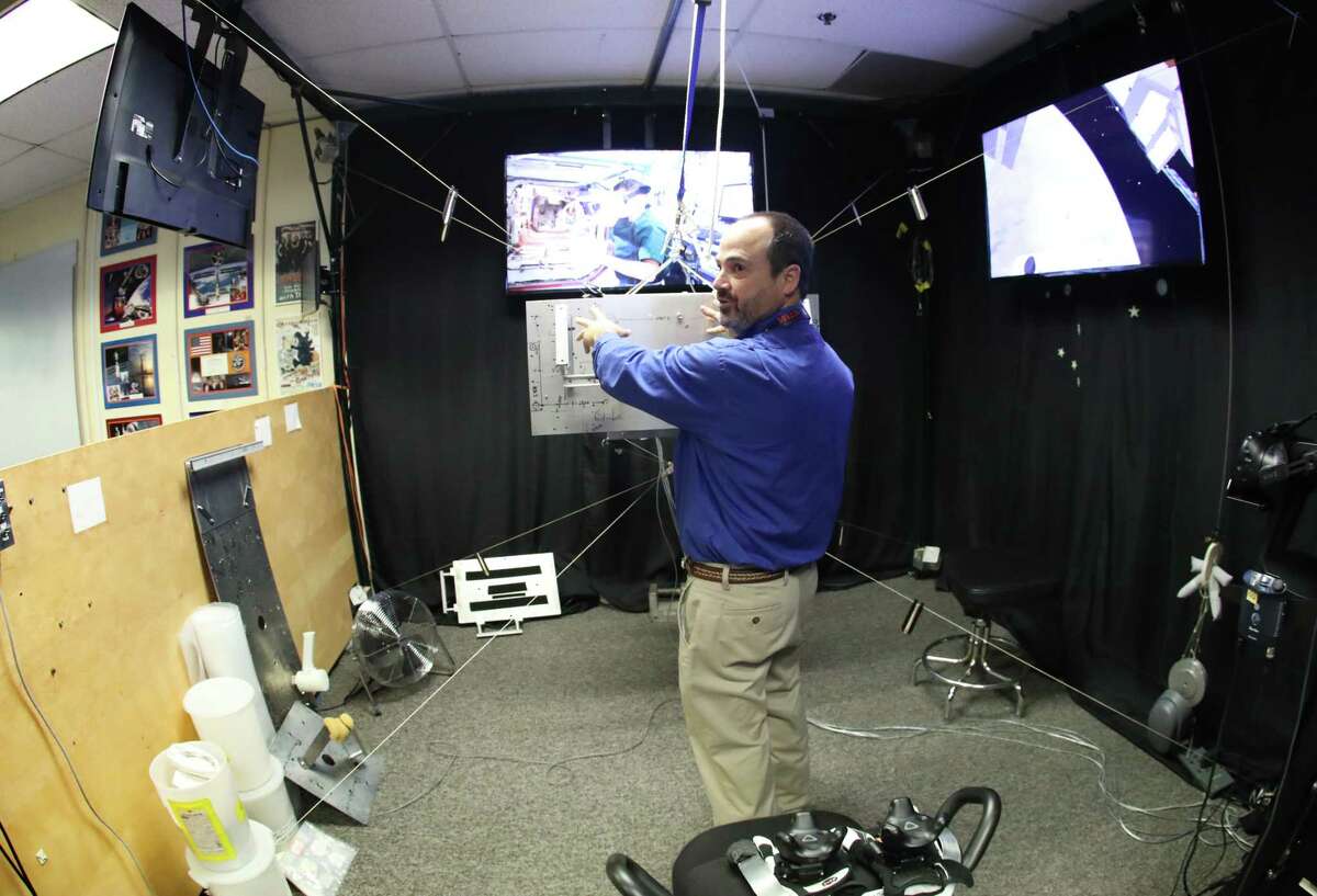 Eddie Paddock talks about the virtual reality at NASA Monday, Feb. 26, 2018, in Houston.