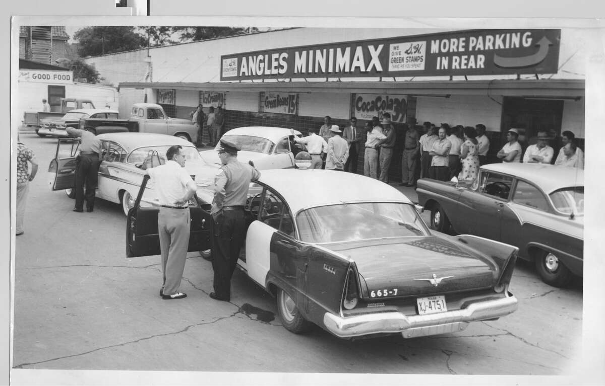 April 18, 1958Aftermath of of robbery outside Angles Minimax Store at Wayside and Navigation. Two men slugged grocery store manager Leonard Heathcook and escaped with $20,000 cash.