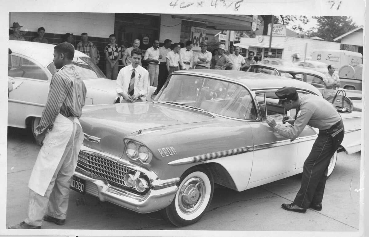 April 18, 1958Aftermath of of robbery outside Angles Minimax Store at Wayside and Navigation. Two men slugged grocery store manager Leonard Heathcook and escaped with $20,000 cash.
