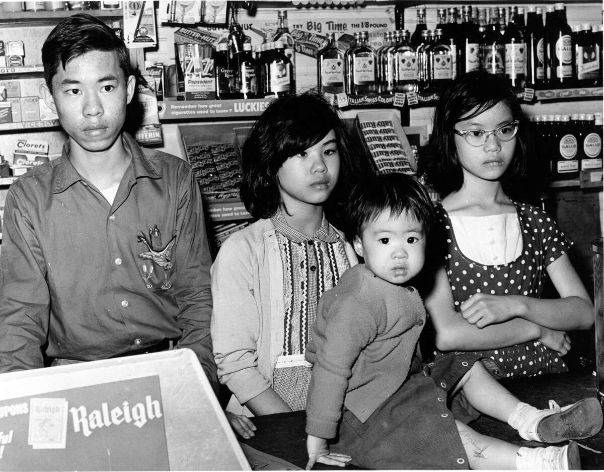 Feb. 1, 1962 The children of slain grocer Joseph Chiu stand behind the counter of their family grocery, J.C. Food Market on Holman. Their father was killed and mother shot in the chest by a robber Feb. 1, 1962. Standing left to right are: James, Mary and Ruth; Rose is seated on the counter.