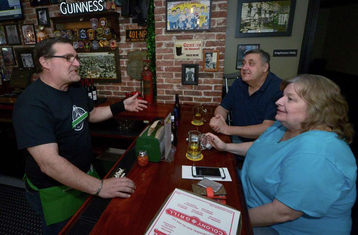 Norwalk police officer Mike Silva chats with customers as he tends bar during the inaugural Norwalk Police Benevolent Association Tip the Finest fundraiser Tuesday, February 27, 2018, at Colony Grill in Norwalk, Conn. About a dozen officers particpated in the PBA event is raising funds for NHS and BMHS post-graduation parties.