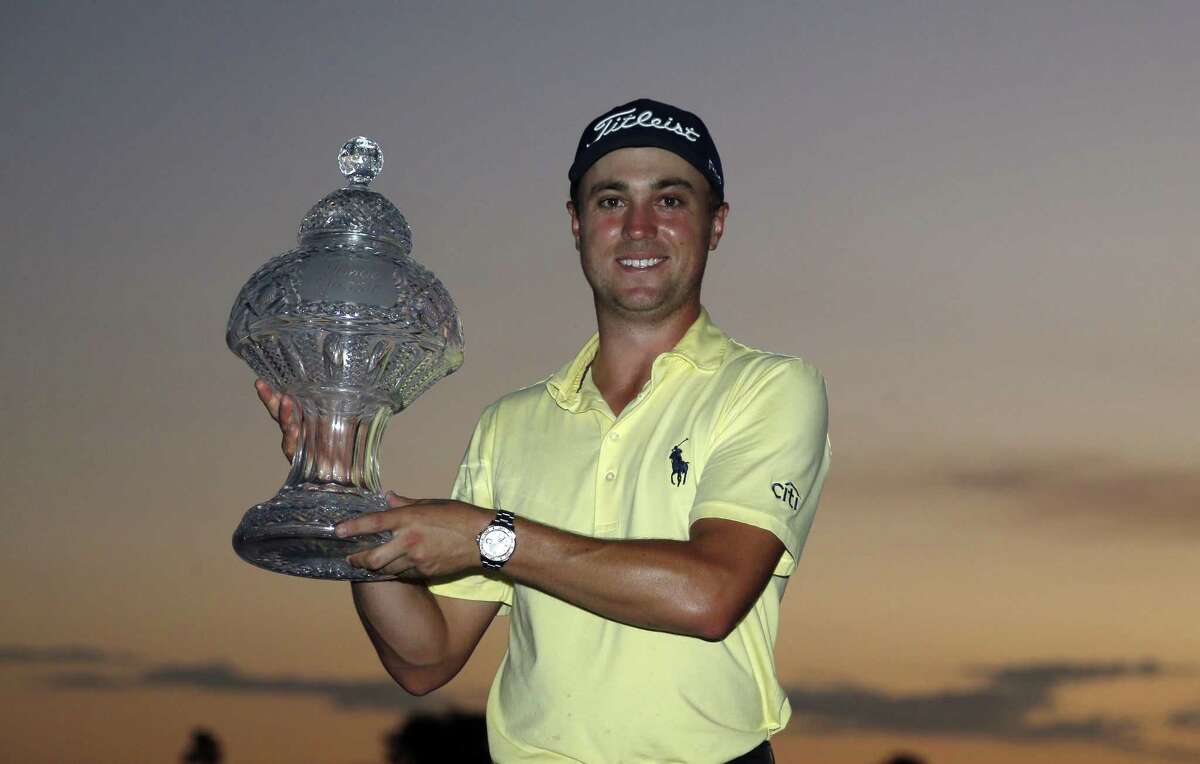 Justin Thomas holds up his trophy after winning the Honda Classic golf tournament in a sudden-death playoff Sunday, Feb. 25, 2018, in Palm Beach Gardens, Fla. (AP Photo/Wilfredo Lee)