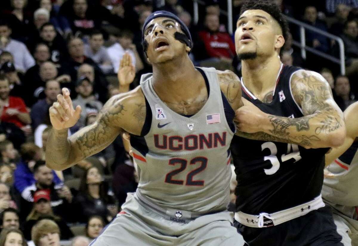 Connecticut’s Terry Larrier (22) and Cincinnati’s Jarron Cumberland (34) battle for a rebound during the second half of an NCAA college basketball game, Thursday Feb. 22, 2018, in Highland Heights, Ky. (AP Photo/Tony Tribble)