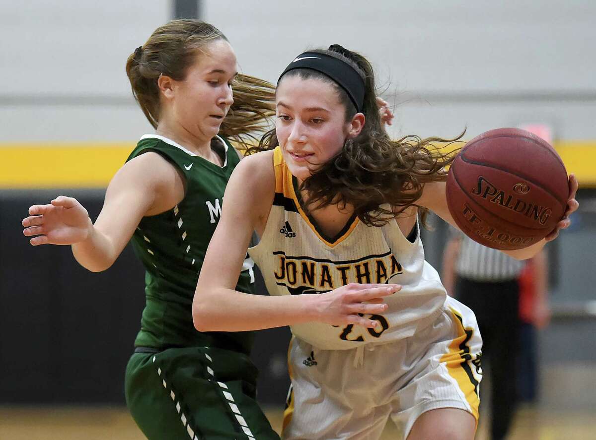Law senior captain Colleen Goodwin drives around Maloney sophomore Olivia Aitken, Tuesday, Feb. 27, 2018, in the fourth quarter of a class L first round matchup of the CIAC state tournament at Jonathan Law High School in Milford. The Lady Lawmen beat Maloney, 62-28.