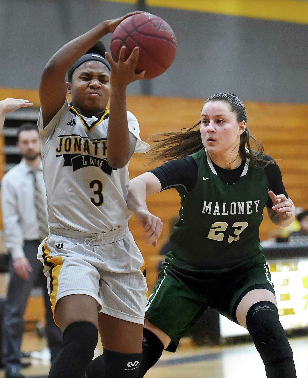 Law junior captain Samara Thacker makes a move on Maloney senior Melanie Polanco, Tuesday, Feb. 27, 2018, in a class L first round matchup of the CIAC state tournament at Jonathan Law High School in Milford. The Lady Lawmen beat Maloney-Meriden, 62-28.