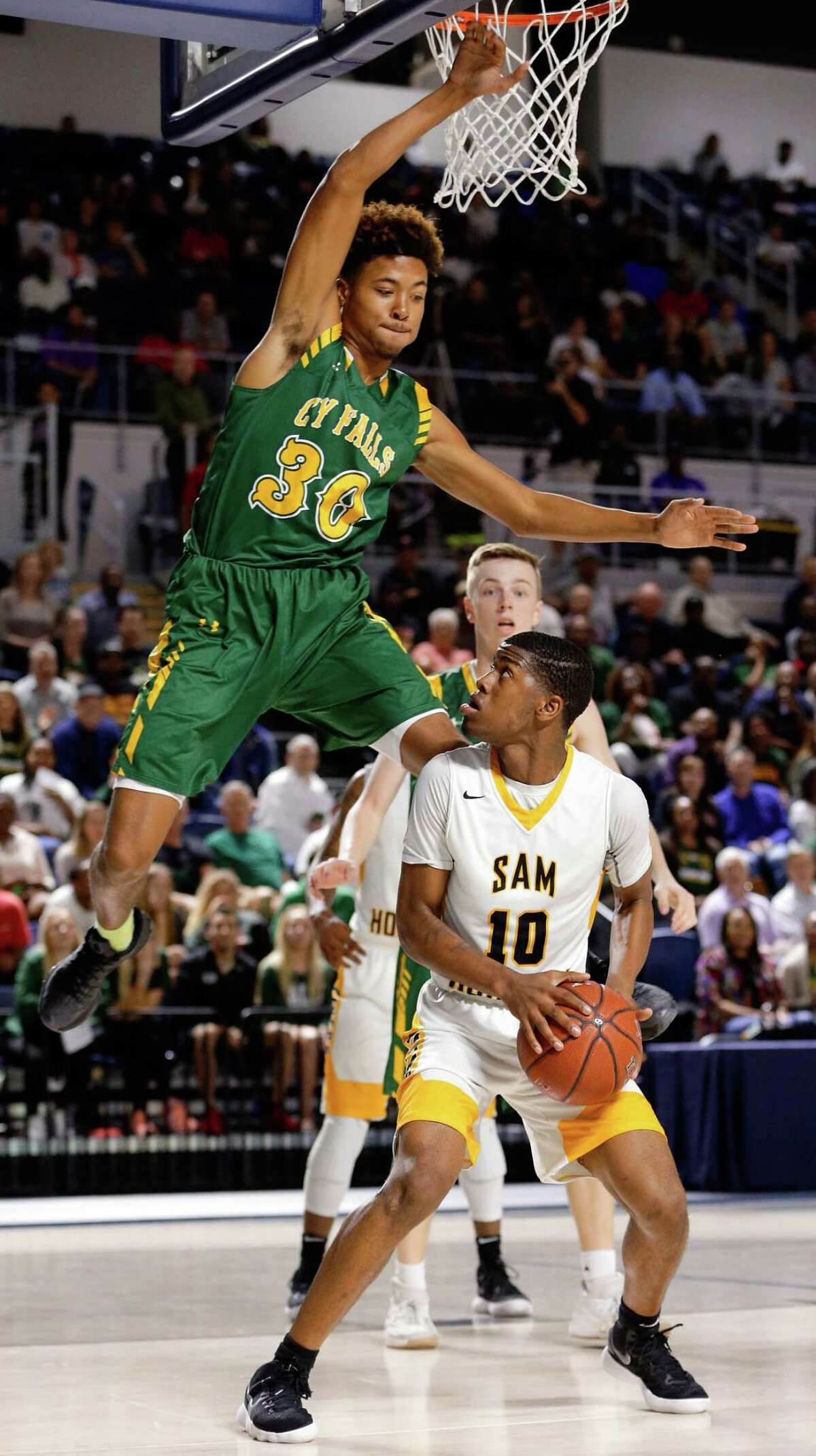 Sam Houston's Chris Green (10) waits to put up his shot as Cy Falls' TJ Goodwin (30) flies by during the first half of their regional quarterfinal game at Delmar Fieldhouse Feb. 27, 2018 in Houston, TX. (Michael Wyke / For the Chronicle)
