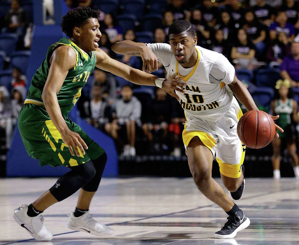 Sam Houston's Chris Green drives around Cy Falls' Austin Guillory during the 2nd half of their regional quarterfinal game at Delmar Fieldhouse Feb. 27, 2018 in Houston, TX. (Michael Wyke / For the Chronicle)