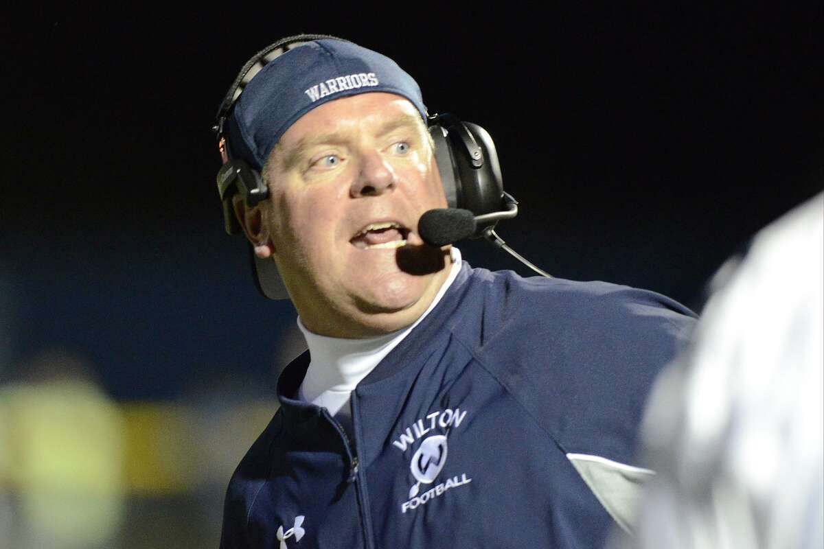 Wilton coach Bruce Cunningham directs his team as Staples High School hosts Wilton High School in varsity football in Westport, on Friday, Sept. 20, 2013. Cunningham stepped down from the position last month.