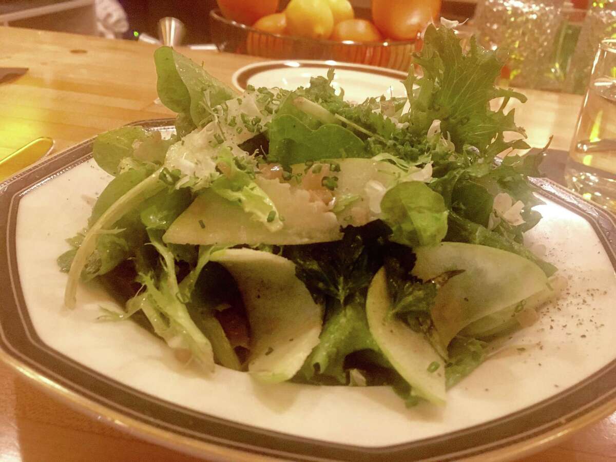 The salad at Nancy's Hustle features good-quality mixed lettuces with a clean, sharp mustard vinaigrette and a whole bunch of fresh herbs and chives, plus a handful of tart green apple slices.