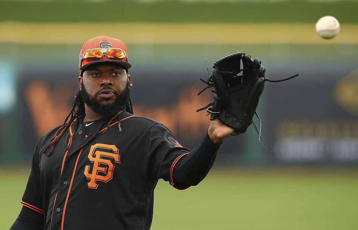 San Francisco Giants' Johnny Cueto makes a catch during a spring training baseball practice on Monday, Feb. 19, 2018 in Scottsdale, Ariz. (AP Photo/Ben Margot)