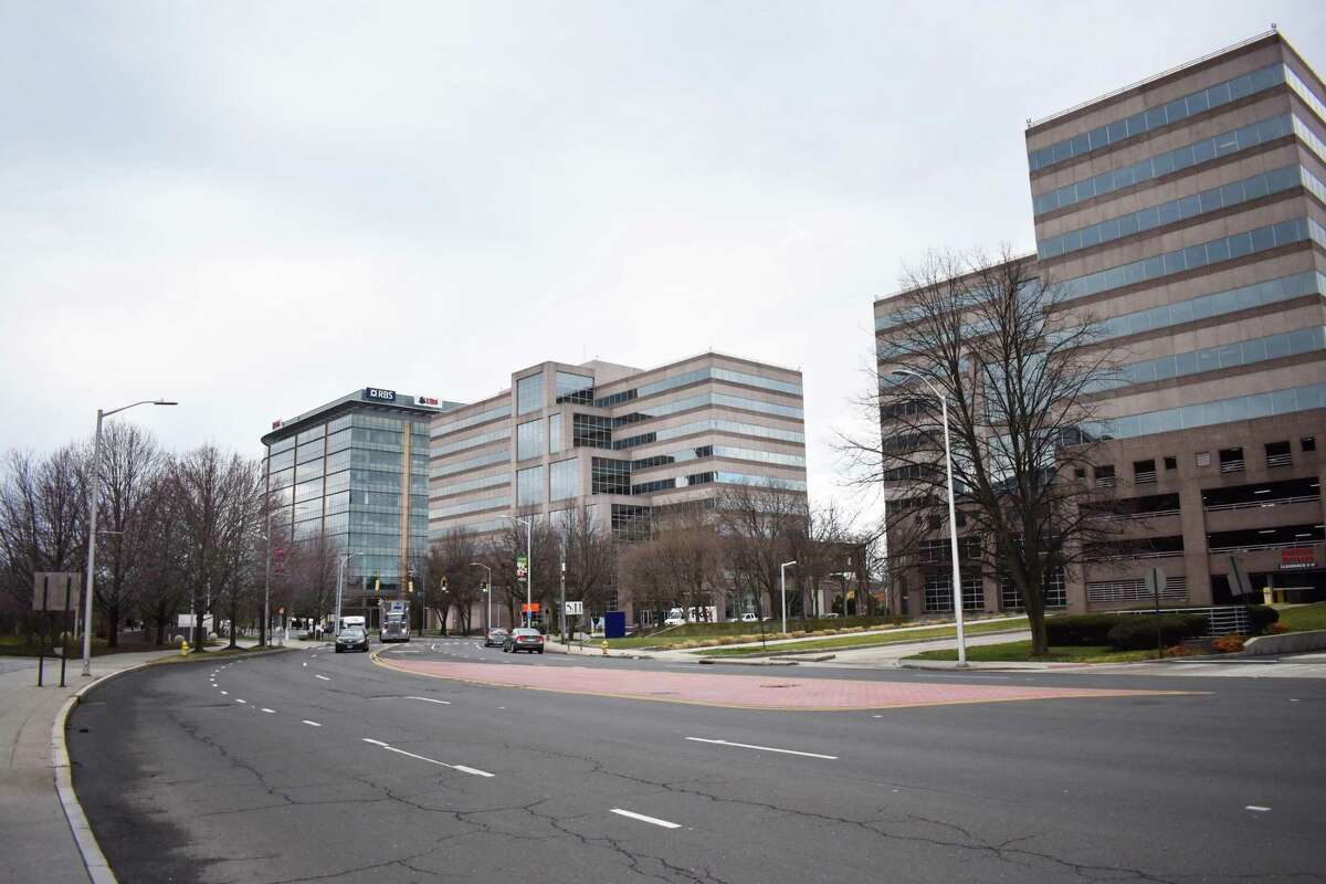 The tandem Stamford Towers complex at 680 Washington Blvd. (center) and 750 Washington Blvd. (right) in Stamford, Conn., with the complex sold in 2017 by SL Green Realty. The real estate investment trust expects the Tax Cuts and Jobs Act of 2017 to boost leasing, as companies put tax savings to work in expansions and hiring.