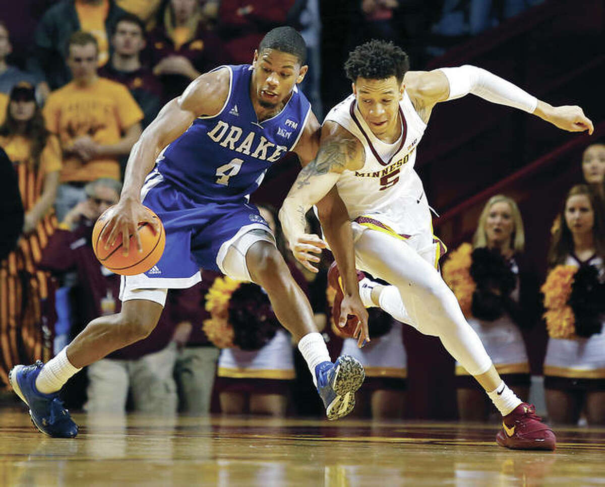 Drake’s De’Antae McMurray (left) battles Minnesota’s Amir Coffey for a loose ball during a game Dec. 11 in Minneapolis. McMurray, an Alton native, will be in St. Louis with the Bulldogs for their opening game Friday at the Missouri Valley Conference Tournament. He is wrapping up a successful college career after a successful prep career split split between Marquette Catholic and Alton High School.