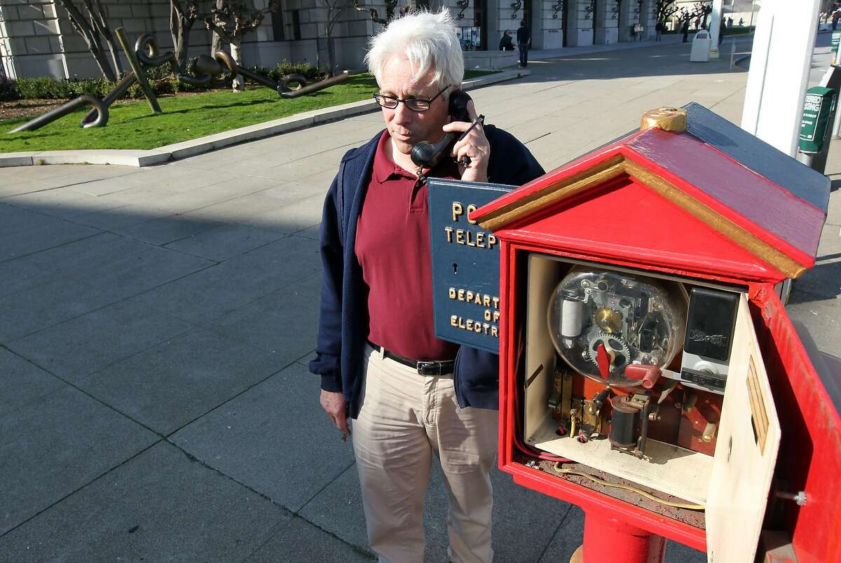 Jack Donohoe from the San Francisco Department of Technology talks to a police dispatcher using the police call box on Van Ness Street. Both Police and fireboxes are dated in the late 1800�s but the Police box phone is modern and was used when most cell phone communications were down during the Loma Prieta Earthquake of 1989. For over a century, blue and red metal police and fire call boxes have dotted San Francisco's landscape. Friday February 3, 2012.