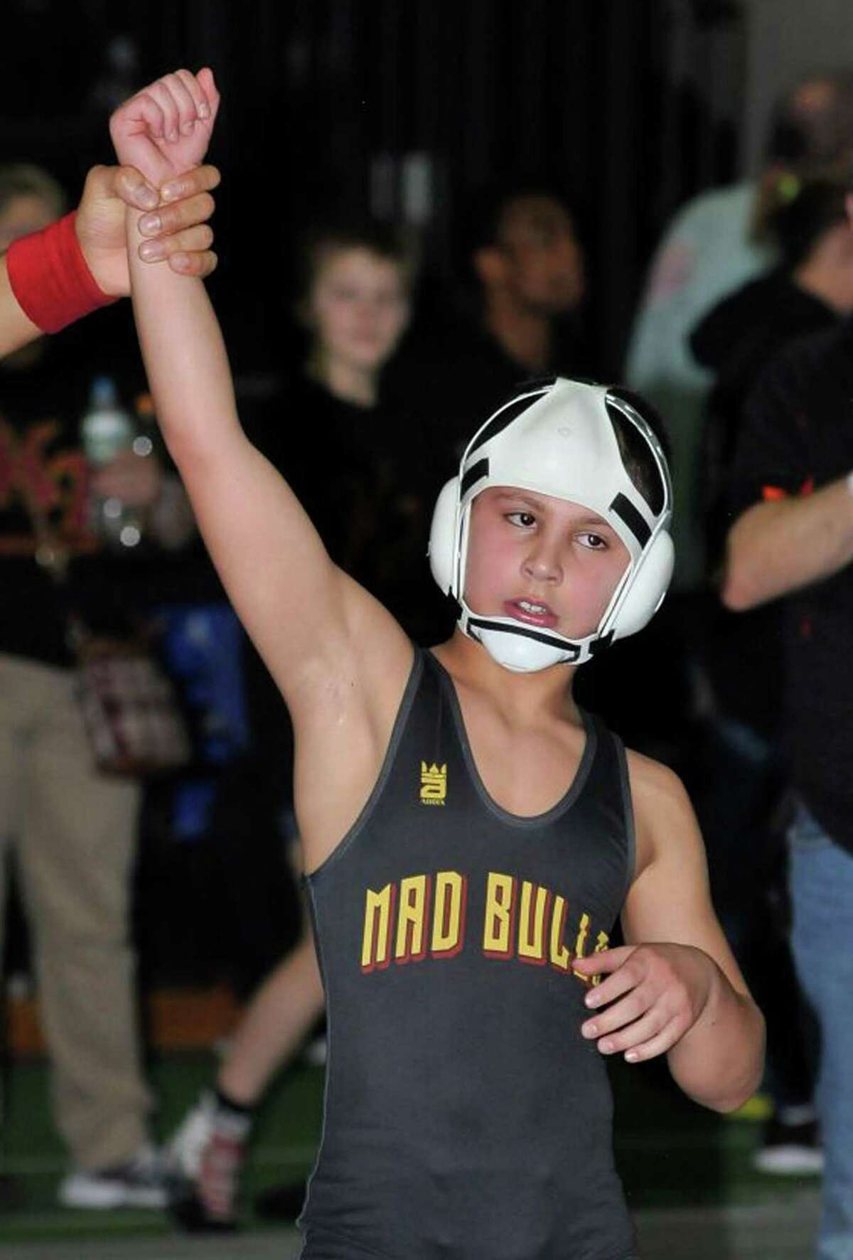 Carlo Tucci celebrates his third consecutive state title as a member of the Norwalk Mad Bulls wrestling team.