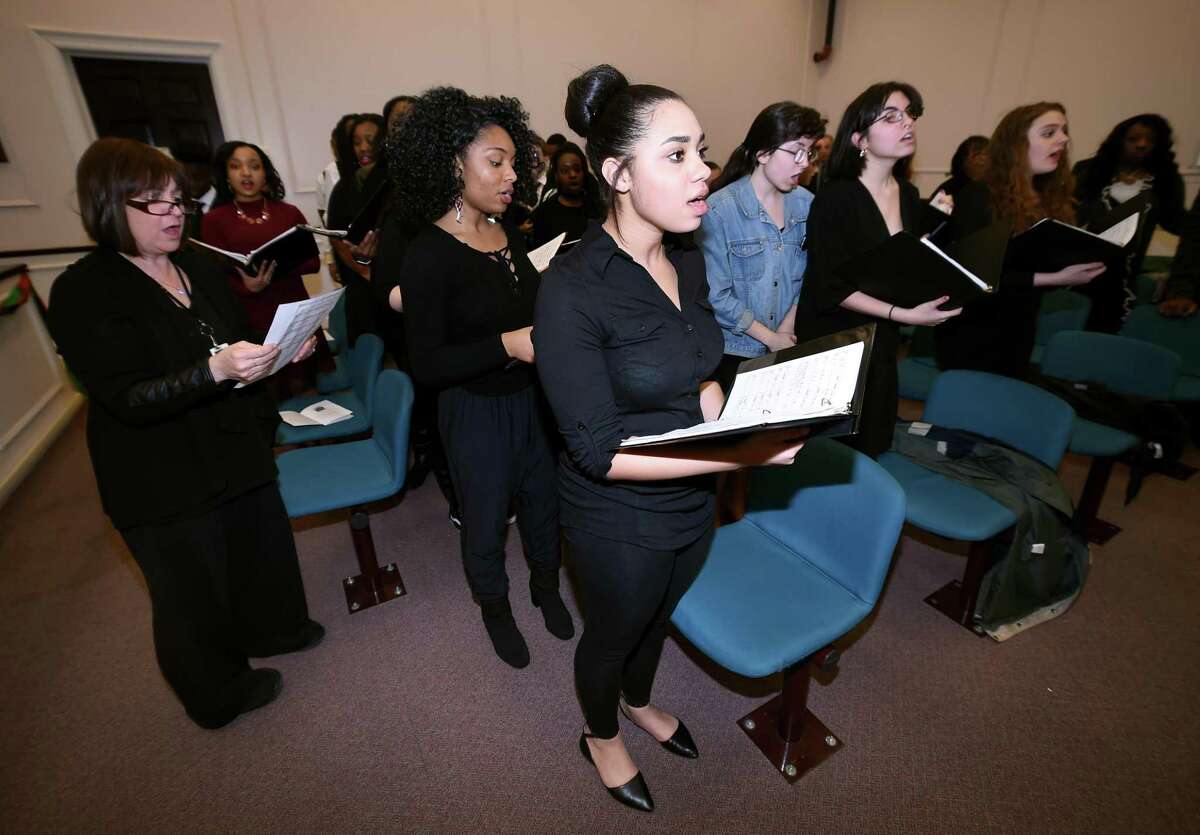 Marie Shakira, center, and the rest of the West Haven High School Bel Canto Chorus sing the Negro National Anthem during the 22nd annual Black Heritage Celebration at West Haven City Hall Wednesday.