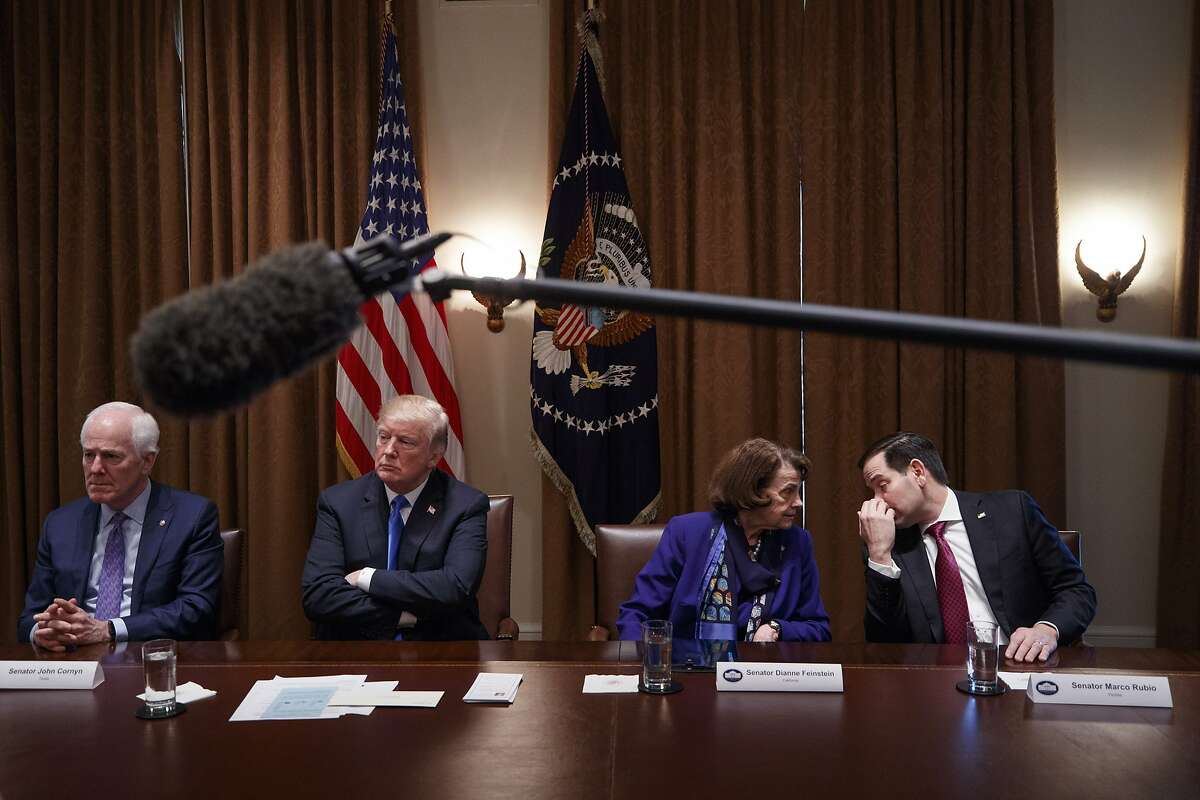 Sens. Dianne Feinstein (D-Calif.) and Marco Rubio (R-Fla.) confer during a bipartisan roundtable talk on gun control, at the White House in Washington, Feb. 28, 2018. Trump repeatedly embraced a series of gun control measures here Monday. From left: Sen. John Cornyn (R-Texas); President Donald Trump; Feinstein and Rubio. (Tom Brenner/The New York Times)