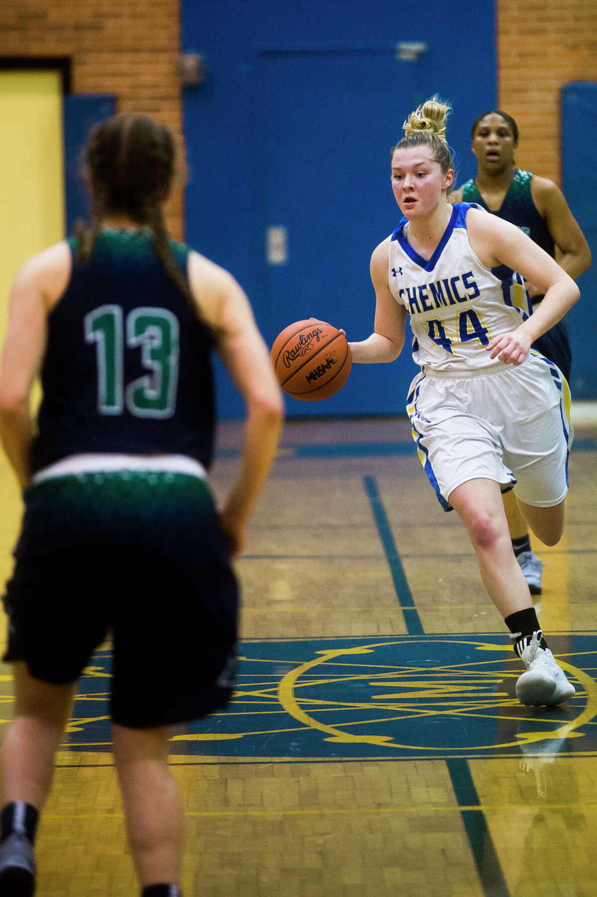 Midland senior Maddie Barrie dribbles down the court during the Chemics' district semifinals game against Saginaw Heritage on Wednesday, Feb. 28, 2018 at Midland High School. (Katy Kildee/kkildee@mdn.net)