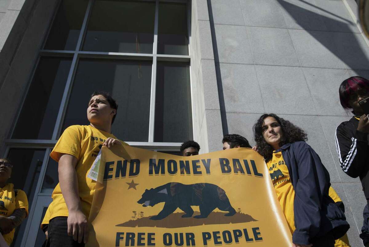 Supporters and activists gather on the steps of the Hall of Justice in San Francisco during a rally calling for the end of the money bail system on Tuesday, February 20, 2018.