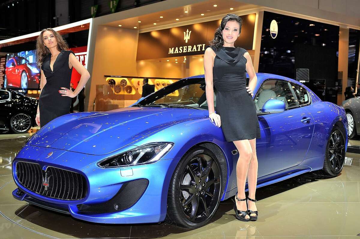 File photo of a Maserati GranTurismo Sport is displayed at the Italian carmaker's booth at the 2012 Geneva Car Show in Geneva. Some manufacturers have forgone scantily clad models, “booth babes” as they are known in the industry, in favor of male and female models dressed in sportswear in this #MeToo environment.