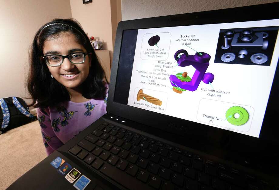 Aditi Bhattamishra, 12, is photographed with her entry in NASA's Future Engineers Two for the Crew Challenge, a restraint and mobility aid she designed for the International Space Station, at her home in Orange on February 27, 2018. Photo: Arnold Gold / Hearst Connecticut Media / New Haven Register