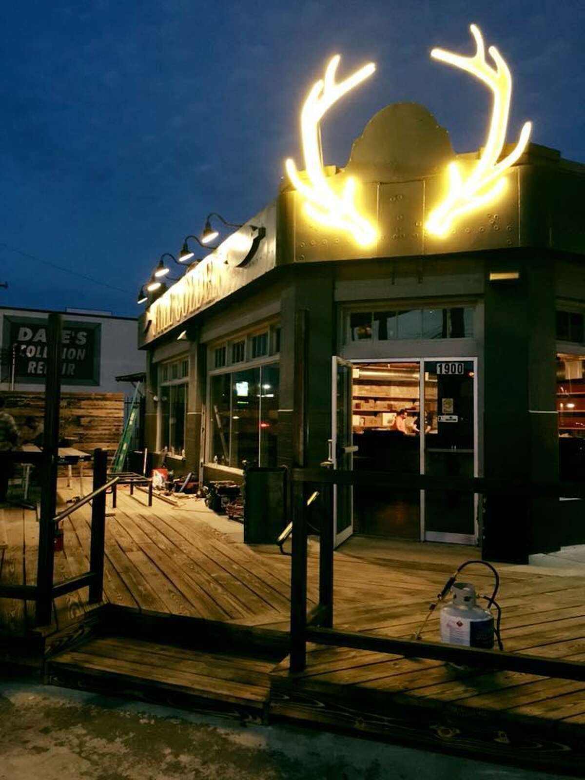 The exterior space at Still Golden features lighted elk horns at the entrance and a large deck that wraps around the bar at the corner of Broadway and Grayson.