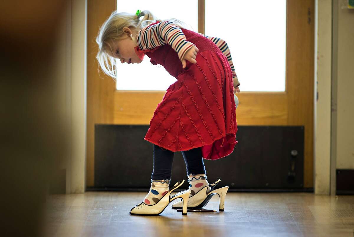 Sadie Scarlett, 5, tries walking in high heels at the Holy Family Day Home on Tuesday, Feb. 27, 2018 in San Francisco, CA. If the child care ballot measure passes, it would help families pay tuition at centers like this one.