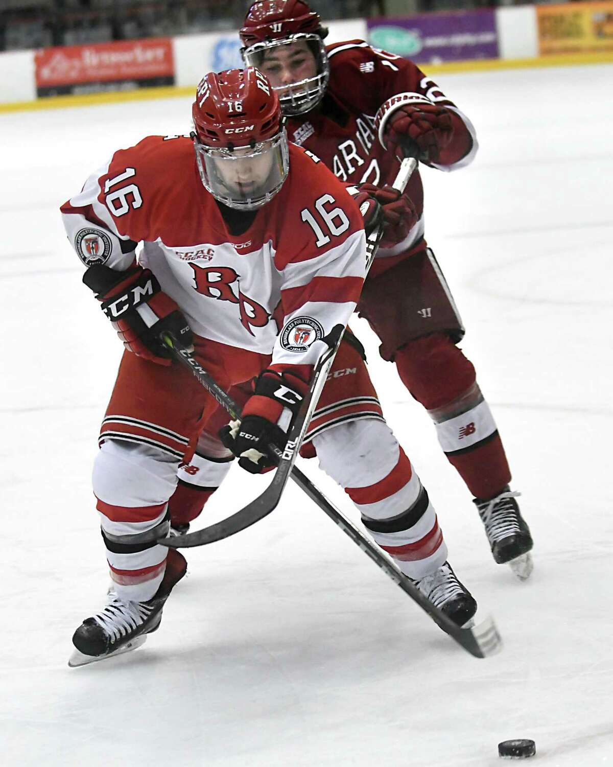 Rensselaer Polytechnic Institute's Jacob Hayhurst is guarded by Harvard's Reilly Walsh during a hockey game at RPI Houston Field House on Tuesday Jan. 9, 2018 in Troy, N.Y. (Lori Van Buren / Times Union)