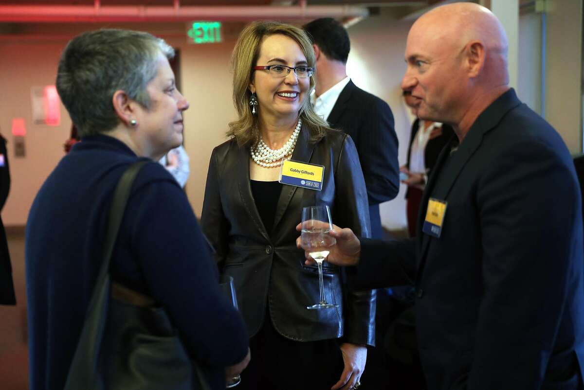 Former US Rep.Gabrielle Giffords and her husband Mark Kelly chat with University of California President Janet Napolitano during a fundraiser for the Gabriel Zimmerman Memorial Scholarship fund in San Francisco, Calif., on Thursday, March 1, 2018.