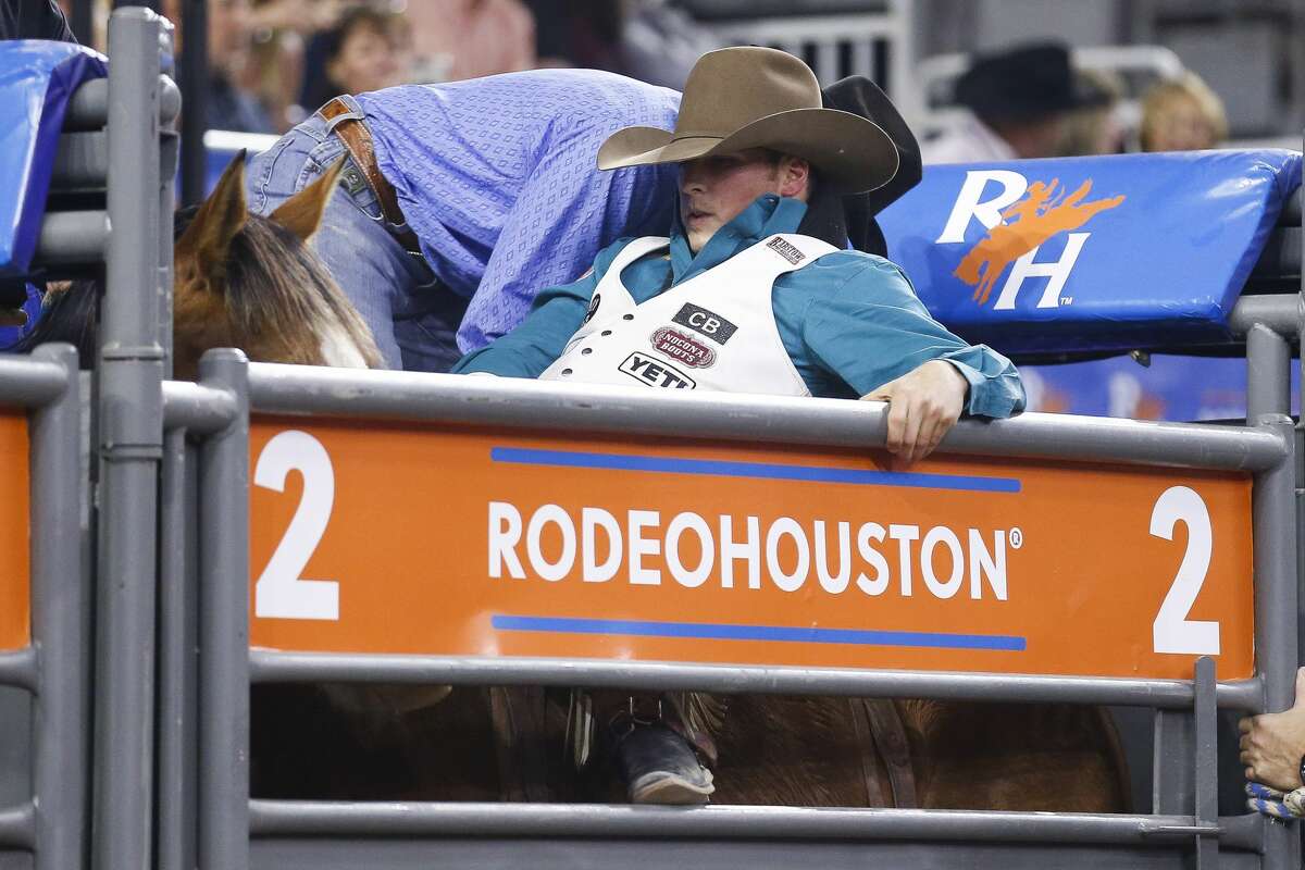 Bareback rider Richie Champion, left, who is from The Woodlands, gets on the back of Lil Bucker during Round 3 of Super Series I at the Houston Livestock Show and Rodeo Thursday, March 1, 2018 in Houston. (Michael Ciaglo / Houston Chronicle)