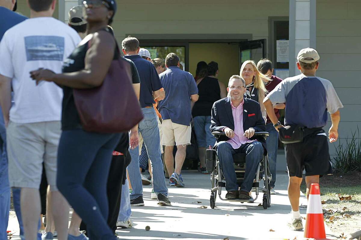 Toby Cole, center, exits the polling place at Nottingham Park during an election in 2016. The county has been sued over accessibility of its voting places by disabled voters.