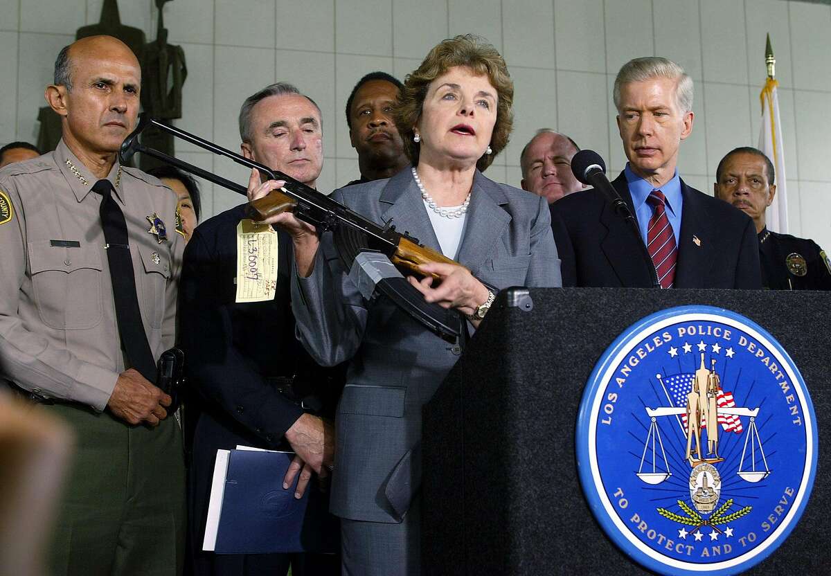 California Senator Diane Feinstein, center, holds up a Chinese made AK-47 as Los Angeles County Sheriff Lee Baca, left, Los Angeles Police Chief William Bratton, Santa Monica Police Chief James T. Butts Jr., and California Governor Gray Davis, right, look on at a news conference in downtown Los Angeles Thursday, Aug. 21, 2003. The group urged Congress to re-authorize the assault weapons ban signed into law in 1994. (AP Photo/Damian Dovarganes)