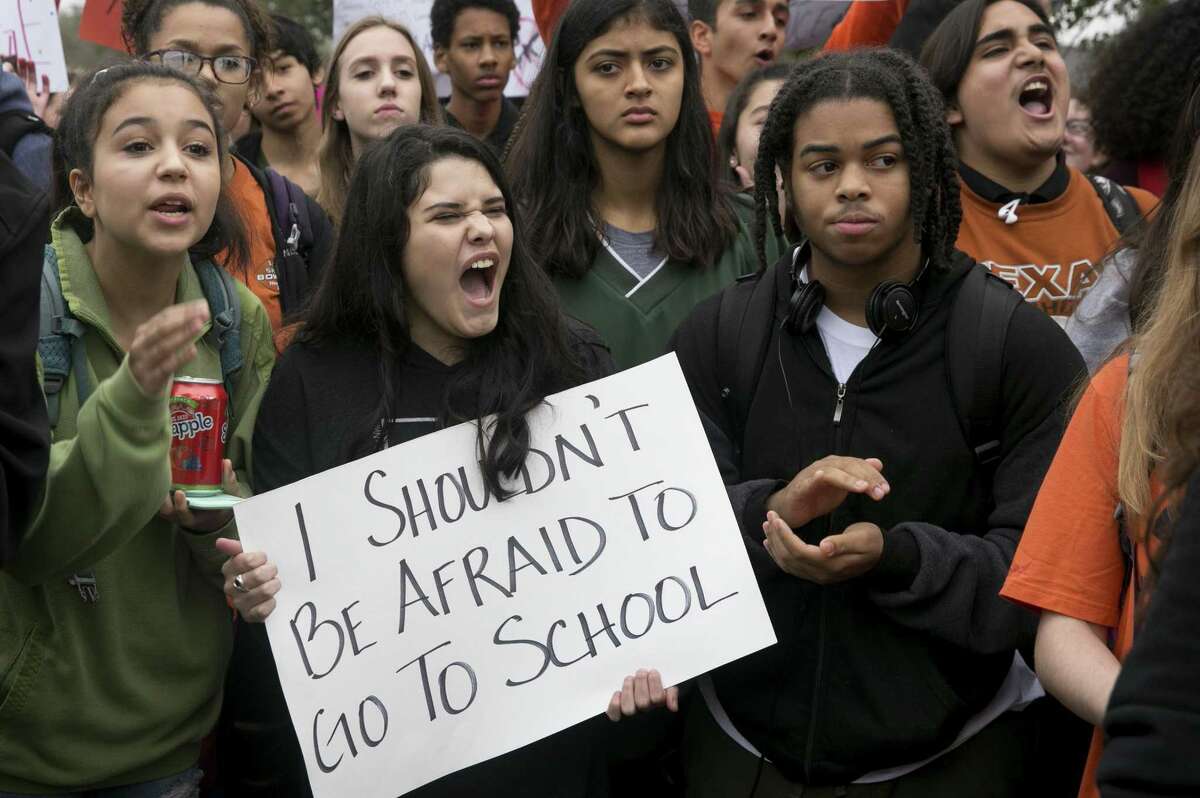 Maya Morales, 15, holds a sign during a walkout and demonstration for gun control at Anderson High School in Austin, Texas, on Friday Feb. 23, 2018. (Jay Janner/Austin American-Statesman via AP)