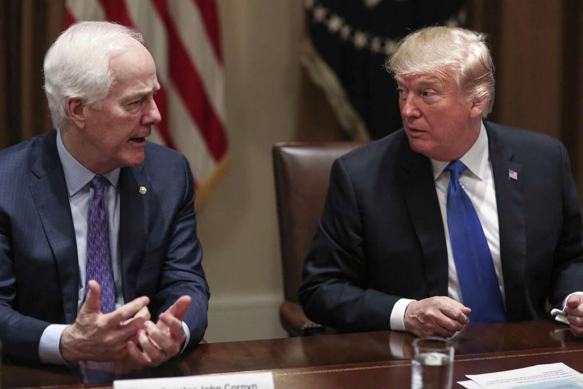 President Donald Trump, right, listens as Senator John Cornyn (R-Texas) speaks during a meeting with bipartisan members of Congress on school and community safety in the Cabinet Room of the White House on Wednesday, Feb. 28, 2018, in Washington, D.C. (Oliver Contreras/Sipa USA/TNS)