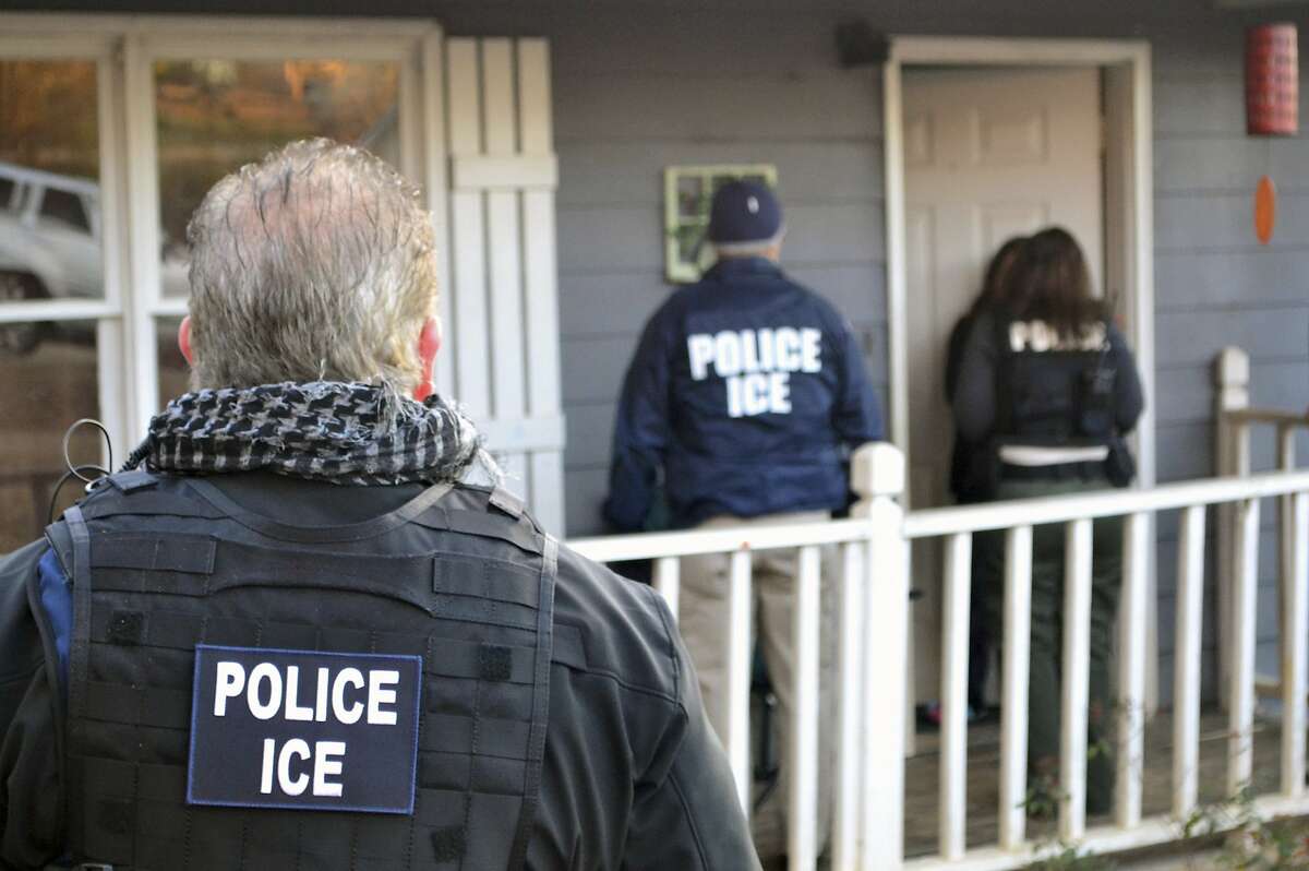 In this Feb. 9, 2017, photo provided U.S. Immigration and Customs Enforcement, ICE agents at a home in Atlanta, during a targeted enforcement operation aimed at immigration fugitives, re-entrants and at-large criminal aliens. The Homeland Security Department said Feb. 13, that 680 people were arrested in roundups last week targeting immigrants living illegally in the United States. (Bryan Cox/ICE via AP)