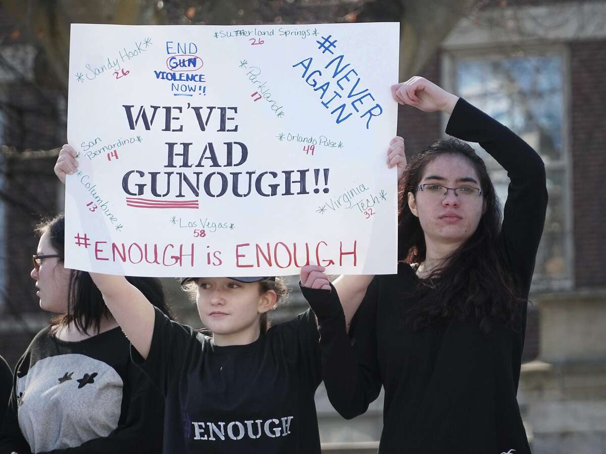 Jessica Snow and Kara Wagner, Seniors at Pittsfield High School stand out to advocate for school safety in response to the school shooting in Parkland, Fla., Tuesday, Feb. 27, 2018 in Pittsfield, Mass. (Ben Garver/The Berkshire Eagle via AP)