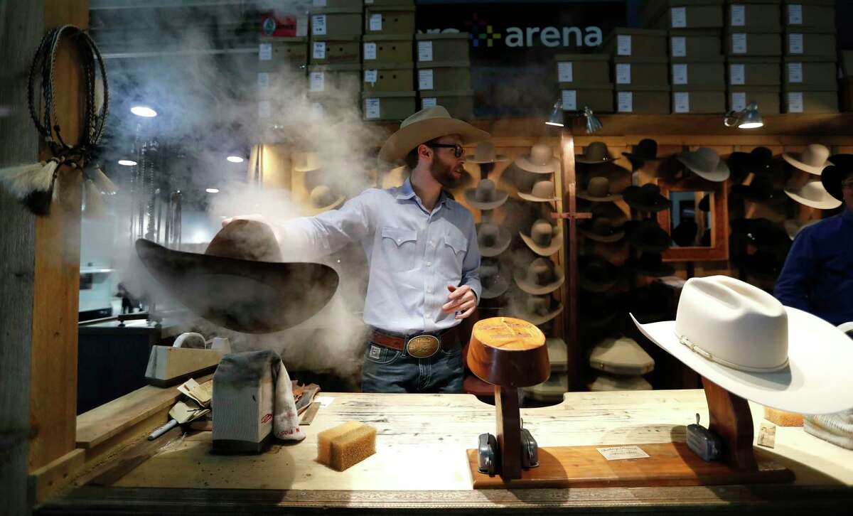 Clay Hand, of Sombrero Brands, steams a hat as he shapes it in their booth during the Houston Livestock Show and Rodeo at NRG Arena, Friday, March 2, 2018, in Houston.