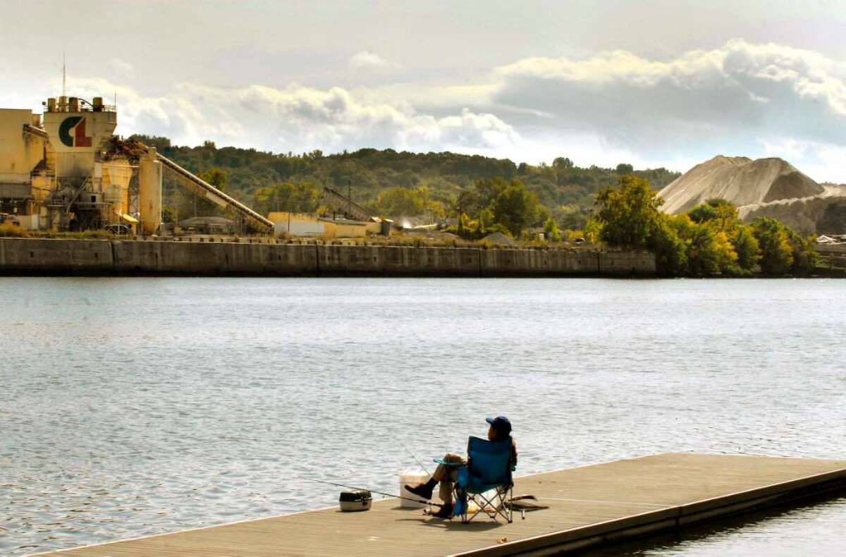 Traditional Hudson River development for heavy industry is observed as a lone person enjoys wonderful fall weather Thursday at the Hudson Shores Park in Watervliet. Recreation, homes and other non-industrial uses are planned for the river. Lack of credit and the recession, however, have stalled plans. (Michael P. Farrell / Times Union )