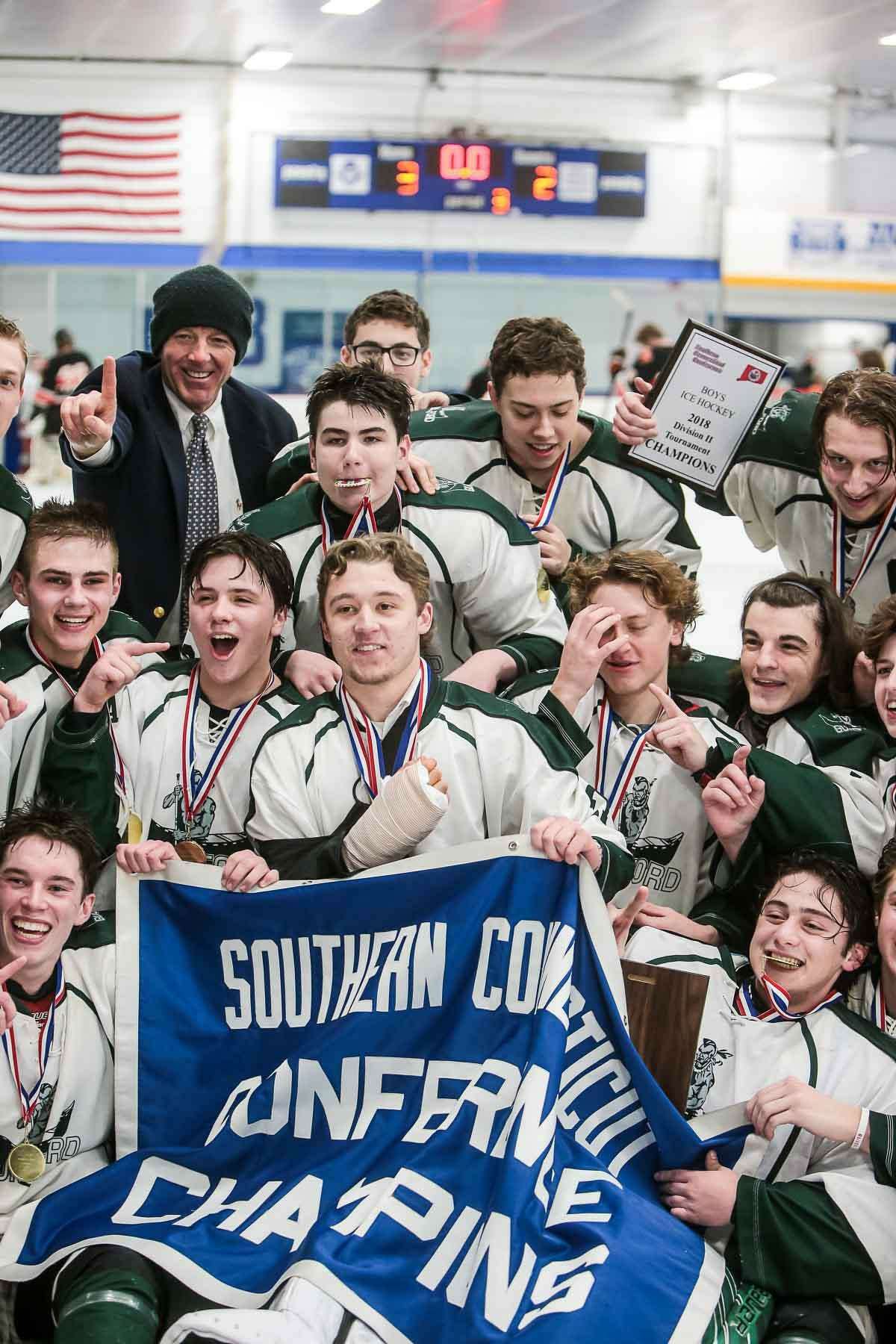 Members of the Guilford hockey team celebrate their win in the SCC-SWC Division II championship game on Saturday at Bennett Rink in West Haven.