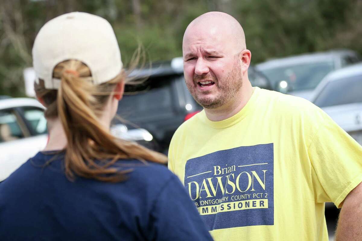 Brian Dawson, candidate for Precinct 2 Commissioner, speaks with voters outside of the South County Community Center polling location during the first day of early voting on Tuesday, Feb. 20, 2018.