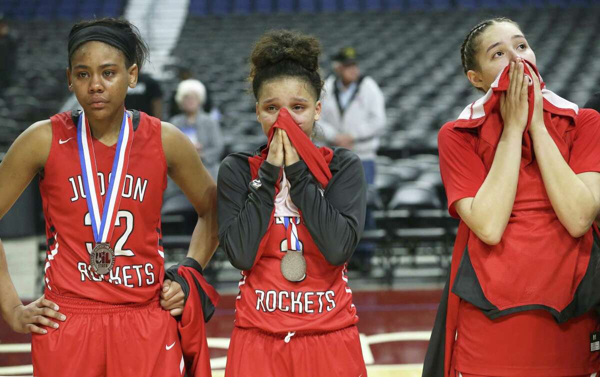 Rocket players (from left) Desiree Lewis, Corina Carter and Kyra White stare in disbelief after giving up a large second have lead to lose the game as Judson plays Plano in the Class 6A high school girls state championship game at the Alamodome on March 3, 2018.