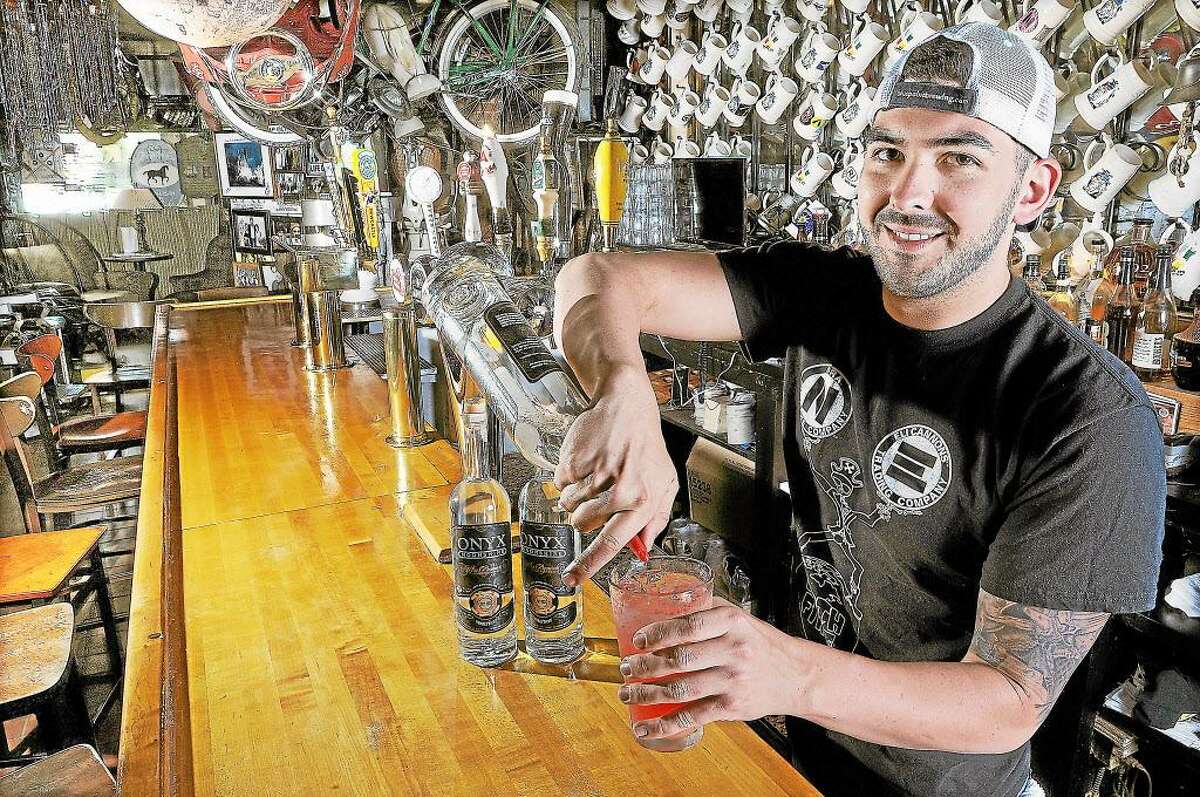 Rocco LaMonica, general manager at Eli Cannon’s on Main Street in Middletown mixes a cocktail. The tap room and restaurant has only sold craft beers during its 25 years in business. The story goes years ago, co-owner Phil Ouellette “threw the Bud guy out of here. The guy told him he would never survive if he didn’t sell Budweiser and Phil said to kick rocks — Phil style.”
