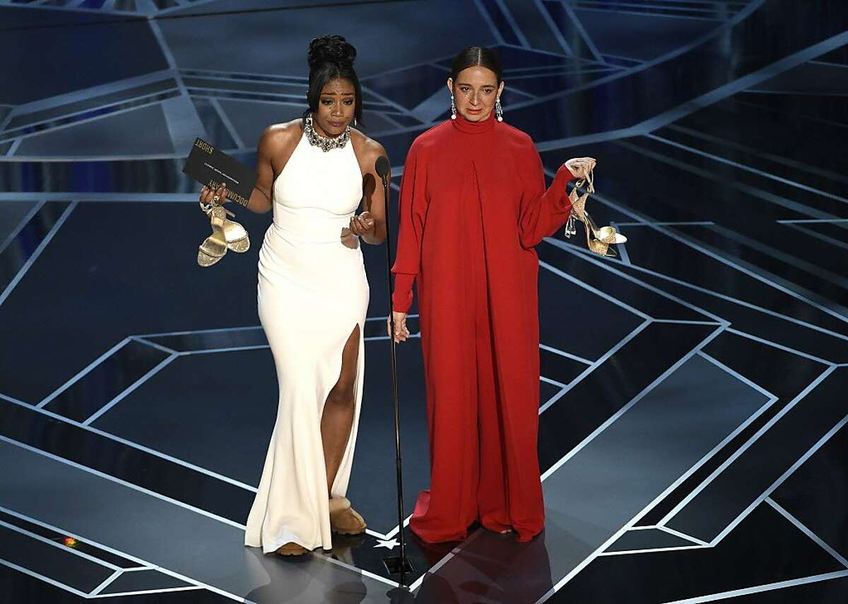 Tiffany Haddish, left, and Maya Rudolph present the award for best documentary short subject at the Oscars on Sunday, March 4, 2018, at the Dolby Theatre in Los Angeles. 