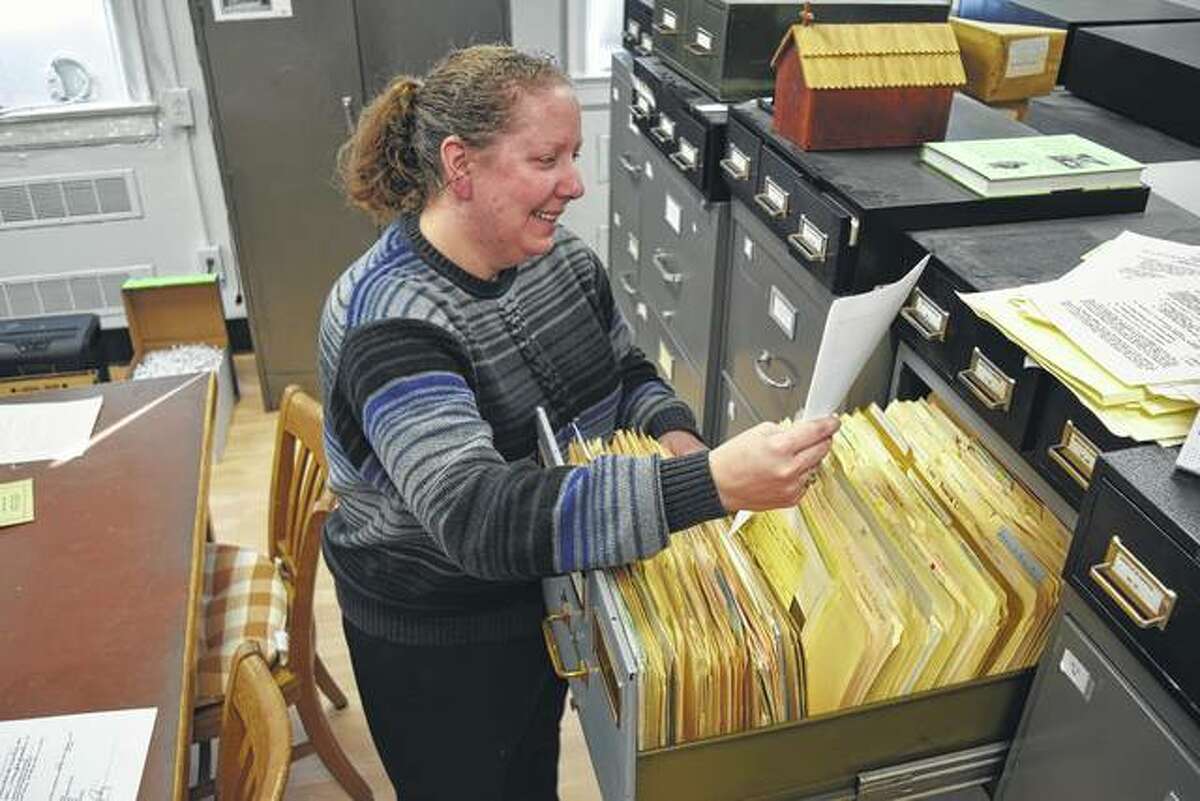Lynne Phillips, the new archivist for MacMurray College and the Illinois Great Rivers Conference of the United Methodist Church, looks through some files at the archives.