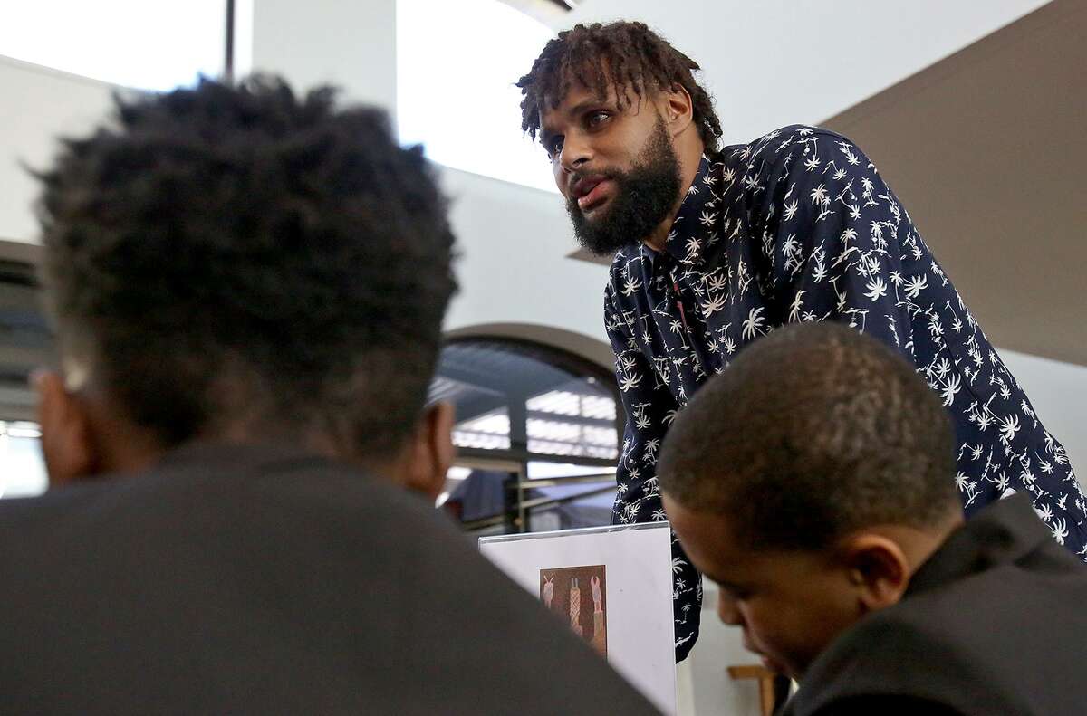 San Antonio Spurs Guard Patty Mills talks with students from the Young Men's Leadership Academy Monday Feb. 26, 2018 at the San Antonio Museum of Art.
