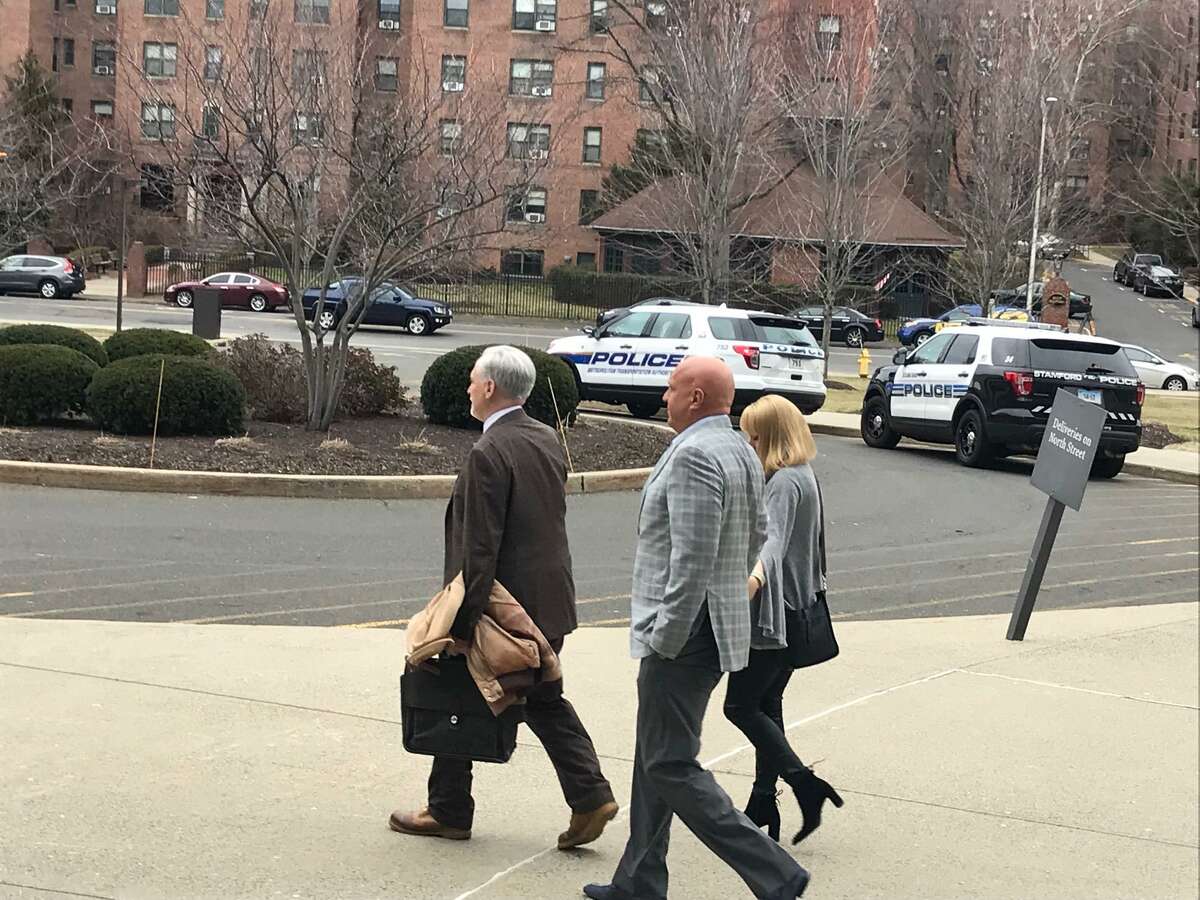 Steve Wilkos leaving the Stamford courthouse where he was appearing for a drunk driving charge. Wilkos is holding hands with a woman and is being led by his attorney Eugene Riccio.