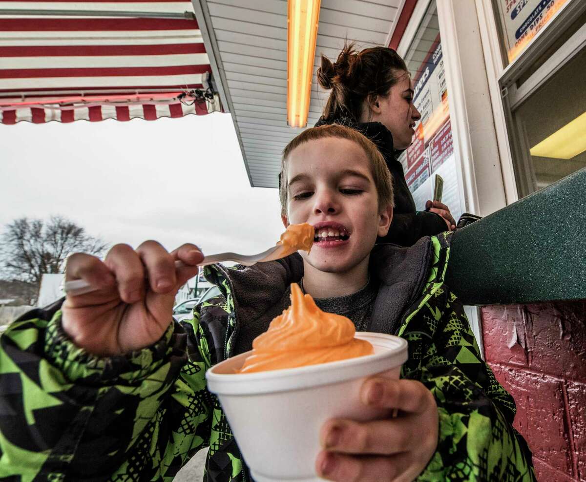 The Snowman Ice Cream shop is open for business even and Jacob Mazur, 6, enjoys some orange sherbet Monday March 5, 2018, in Troy, N.Y. (Skip Dickstein/Times Union)