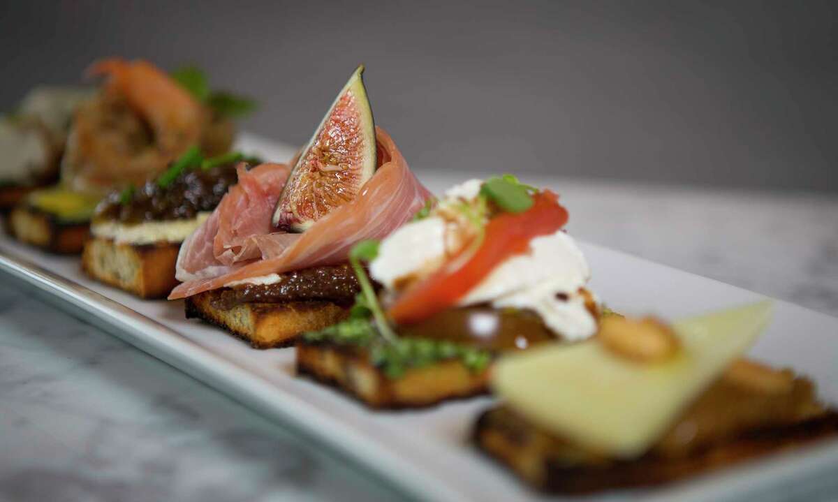 Six of the signature crostini including (L to R) the Mushroom, Burrata, Goat Cheese, Manchego, Shrimp and Prosciutto at the Fig & Olive, a new restaurant in the Galleria opening March 9.