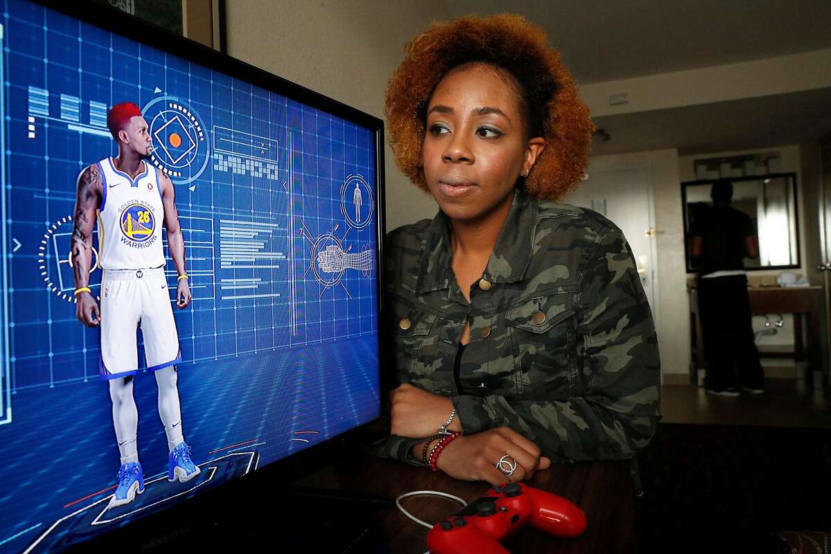 Sabrina Patton with the player she created, Giovanni Patton that she controls in the playstation game video game NBA 2K18, seen in Hayward, Calif., on Fri. Mar.2, 2018. She and her boyfriend Toussaint Taylor have hopes of being drafted by the Golden State Warriors to play a new e-sports league, the inaugural NBA 2K league.