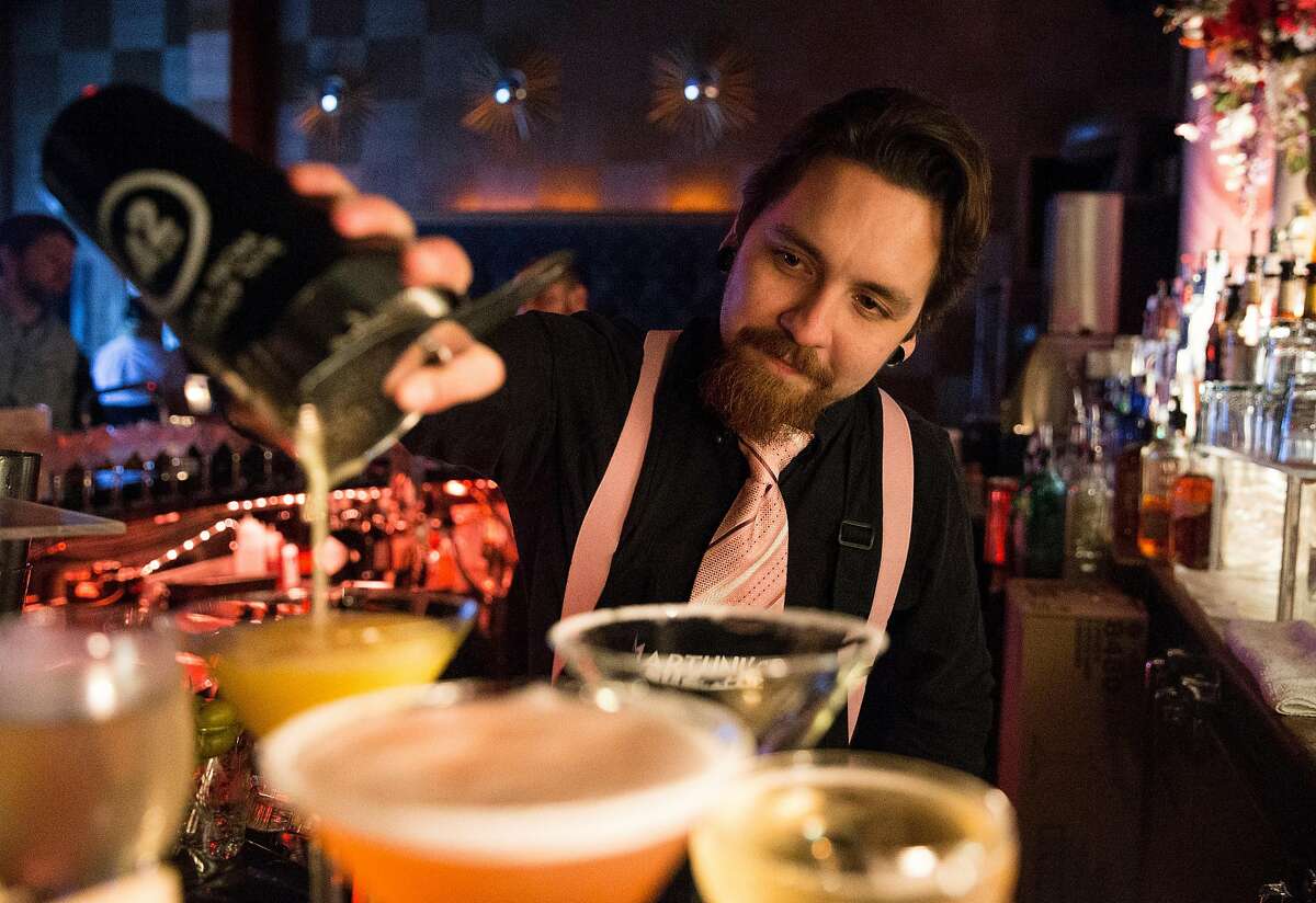 Bartender Vlad Korishev pours a Creamsicle at Martuni's Friday, March 2, 2018 in San Francisco, Calif.