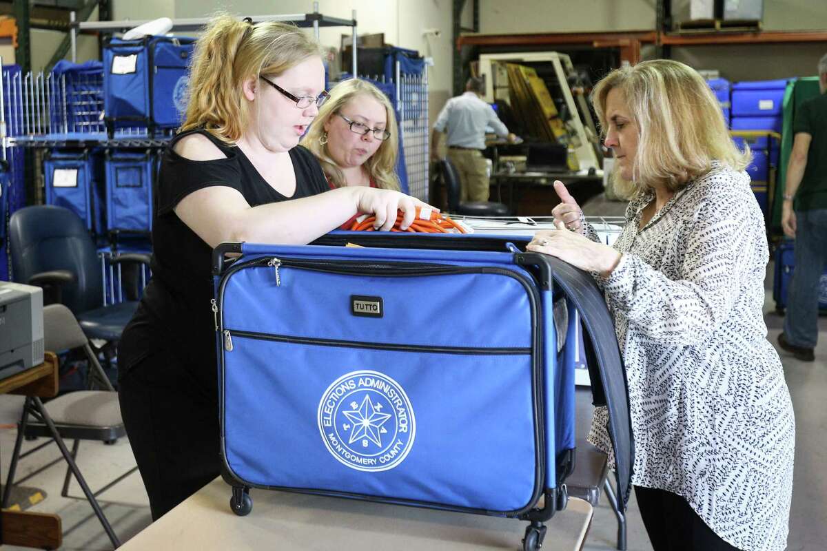 Montgomery County Elections clerks Dusty Day, left, and Jennifer Sheffield, center, assist election co-judge Kathryn Jackson, right, during primary election preparations on Monday, March 5, 2018, at Elections Central in Conroe.